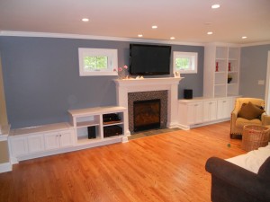 Full wall built-ins with fireplace mantle and surround